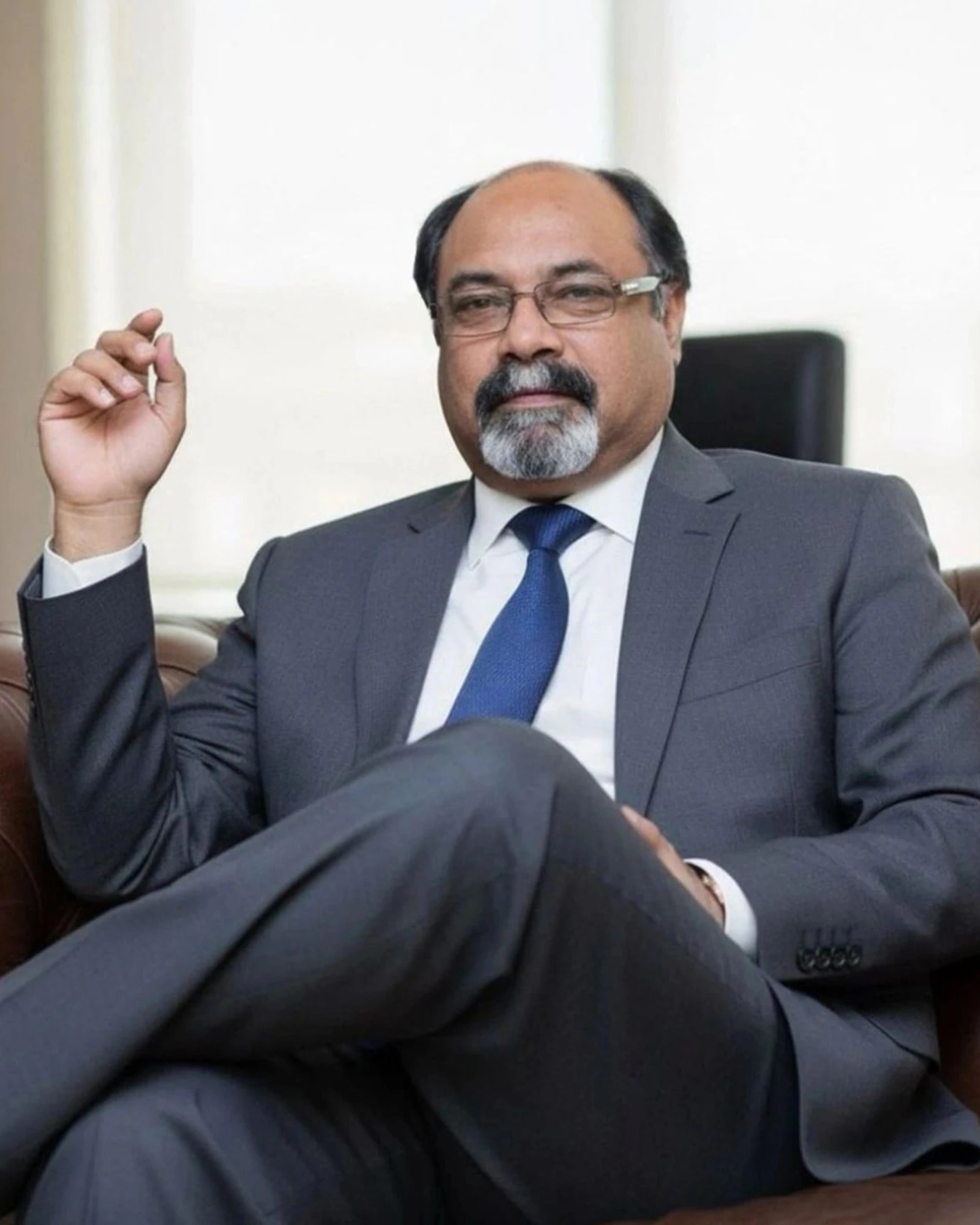 Portrait of Syed Zamir Ahmad Naushahi, CEO and Founder of GFX-T, seated in a grey suit